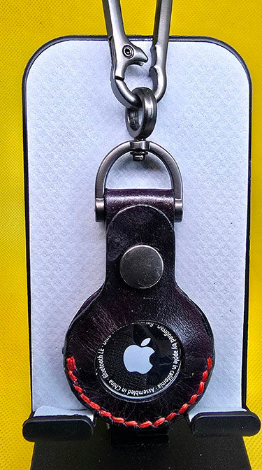 Black premium quality leather apple airtag case with red stitching and keychain.