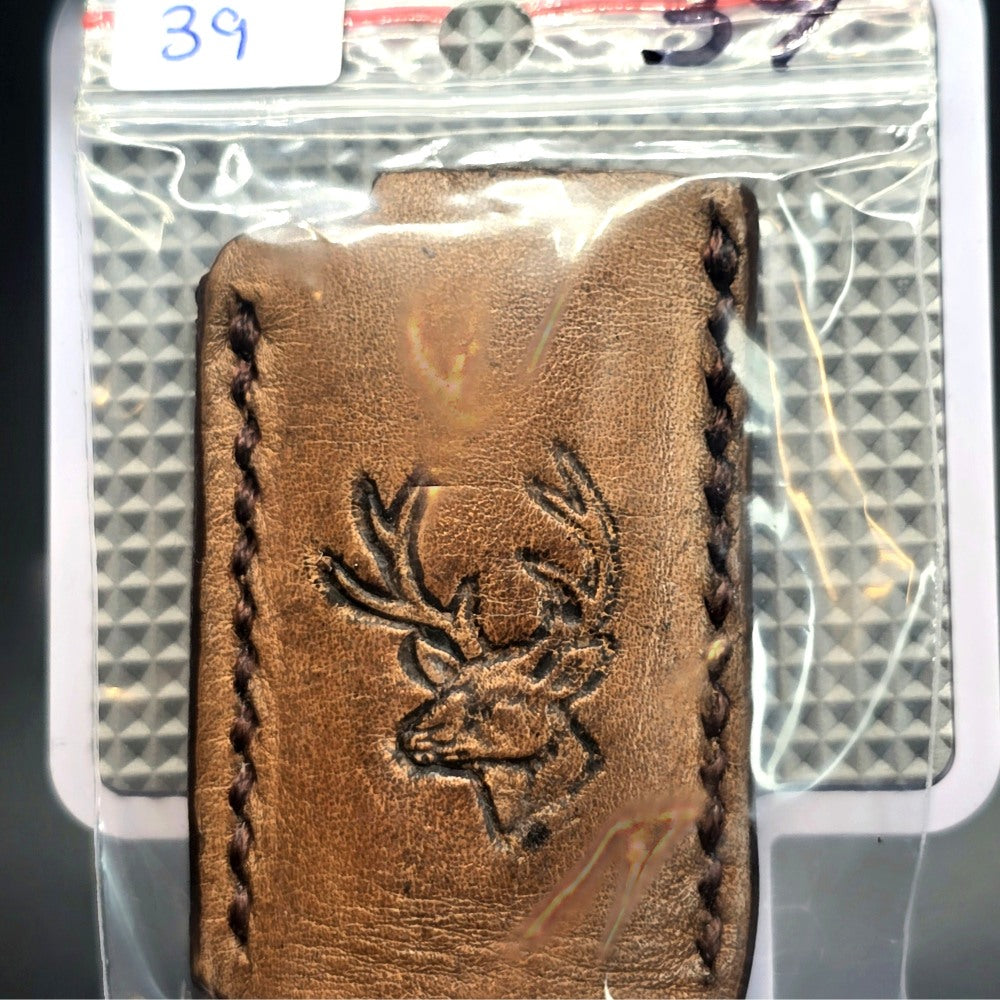 Veg-tan leather lighter case for bic lighters with a picture of a deer in its retail packaging.