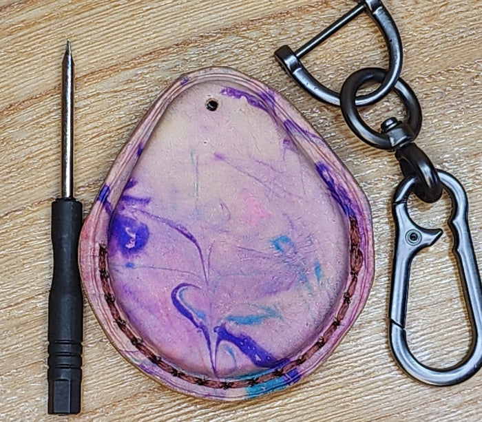 Back view of a flashy, tie dye style premium vegetable tanned leather Harley Davidson key fob case with keychain and mini screwdriver.