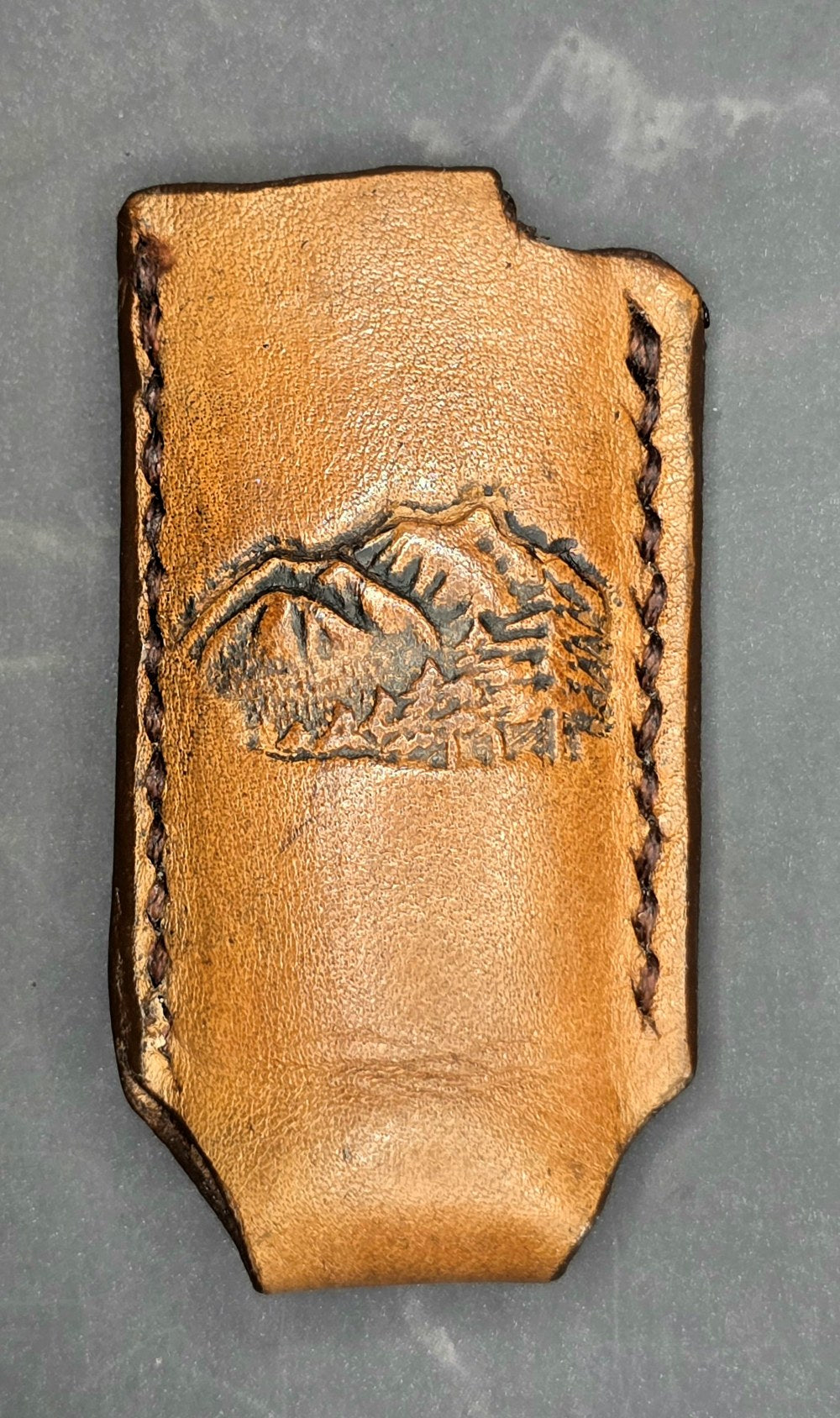 Veg-tan leather lighter case for bic lighters with mountains.