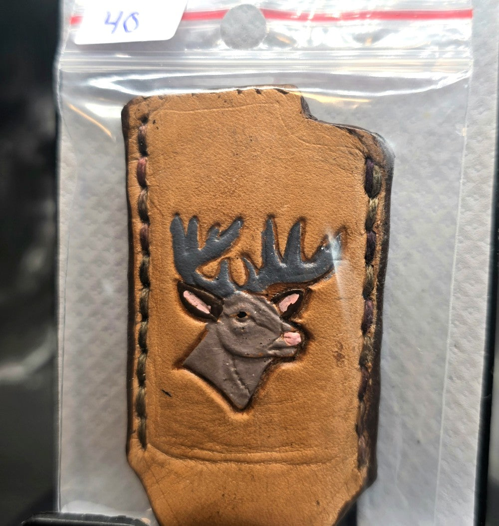 Veg-tan leather lighter case for bic lighters with a hand-painted, embossed deer picture.