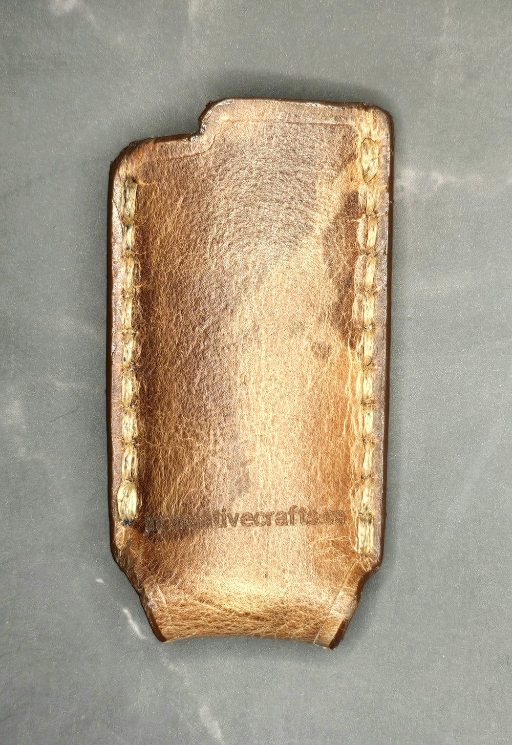 Picture of a Canadian Crafted veg-tan leather lighter case for bic lighters. Made in Canada.