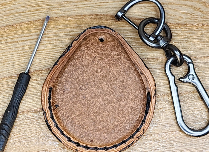 Back view of a brown, premium vegetable tanned leather Harley Davidson key fob case with keychain and mini screwdriver.