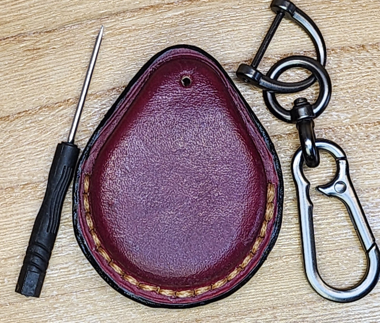 Burgundy veg-tan leather key-fob case for Harley Davidson motorcycles with keychain and screwdriver.
