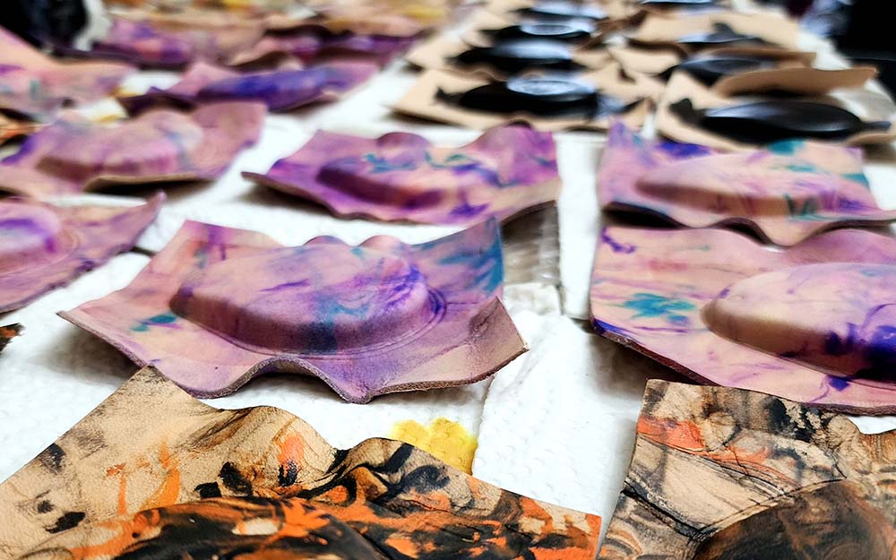 Leather fob cases for Harley Davidson motorcycles being laid out to dry after being dried