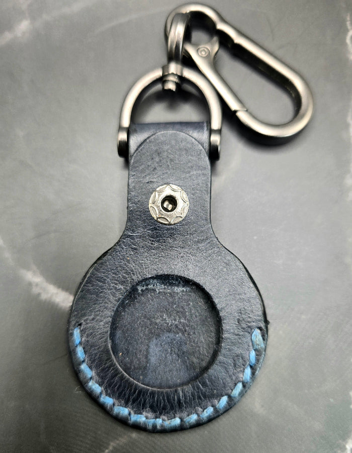 Video of a black colored vegetable tanned leather Apple Air tag holder on a lobster clasp keychain.