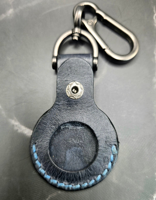 Video of a black colored vegetable tanned leather Apple Air tag holder on a lobster clasp keychain.