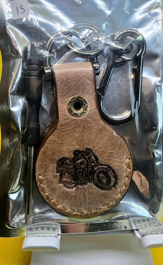Brown veg-tanned leather apple airtag holder with lobster clasp style  keychain in a bag with a small screwdriver.