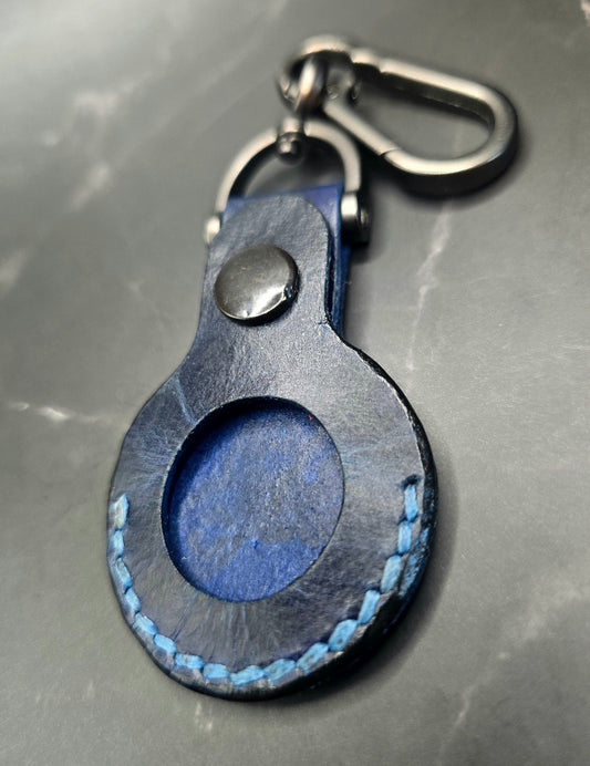 Navy blue Vegetable tanned leather apple airtag case with a stainless steel  lobster clasp keychain.