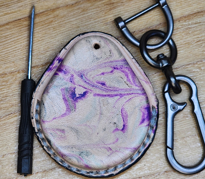 Back view of a flashy, tie dye style premium vegetable tanned leather Harley Davidson key fob case with keychain and mini screwdriver.