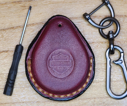 Burgundy veg-tan leather key-fob case for Harley Davidson motorcycles with keychain and screwdriver. 
