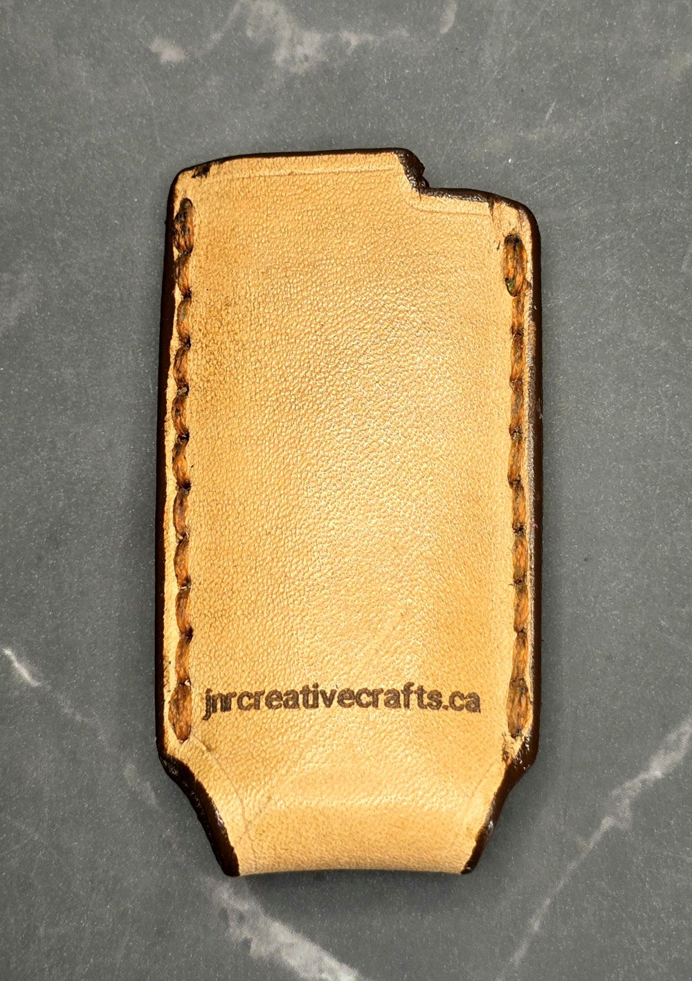 Light brown veg-tan leather Bic lighter case.