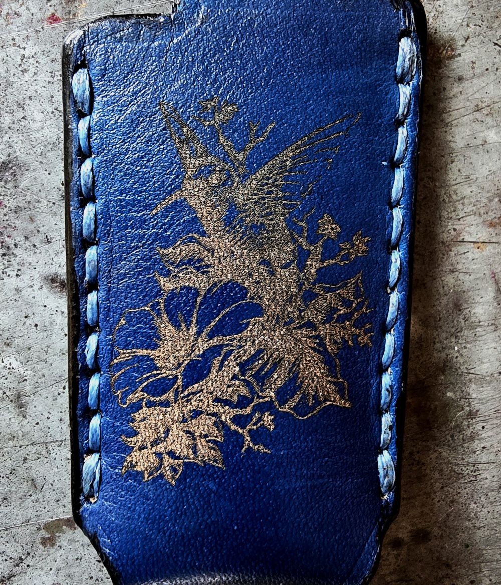 Navy blue veg-tan leather Bic lighter case with a hummingbird laser engraved into it. Handcrafted by JnRcreativeCrafts.