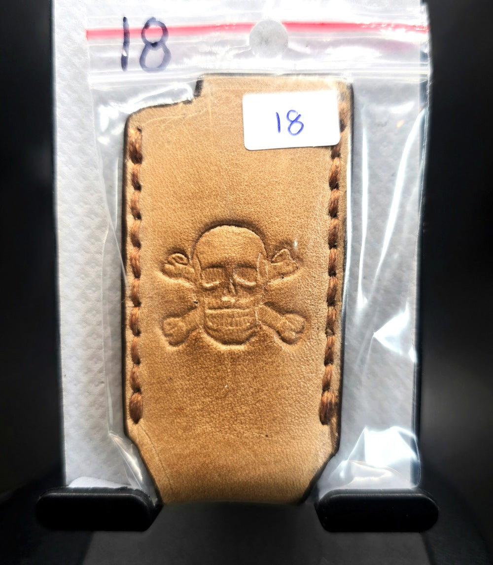 Light brown vegetable tanned leather lighter case for bic lighters with a skull and crossbones stamped into it. Made in Canada by JnRcreativeCrafts.