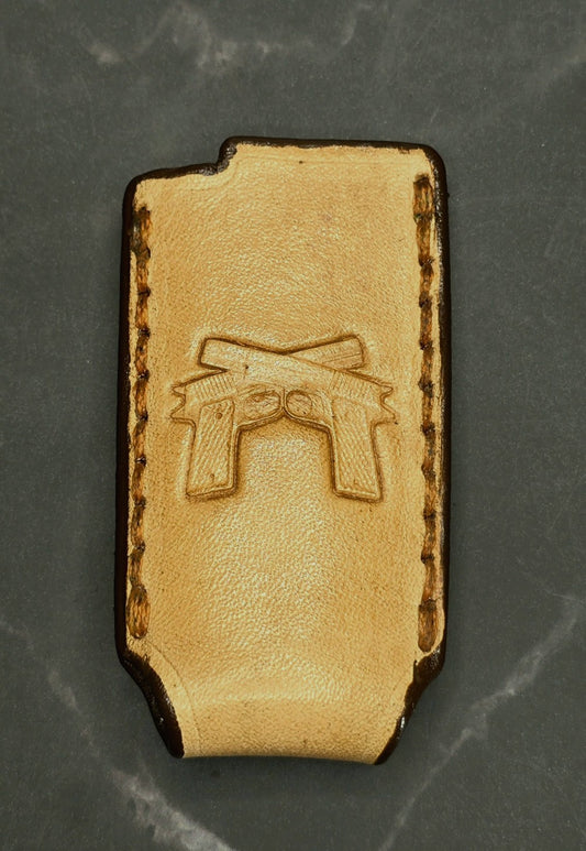 Light brown veg-tan leather Bic lighter case with a pair of handguns stamped into it.
