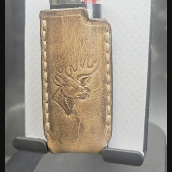 Video of a hand-crafted veg-tan leather lighter case for bic lighters with a deer stamped into it. Canadian made.