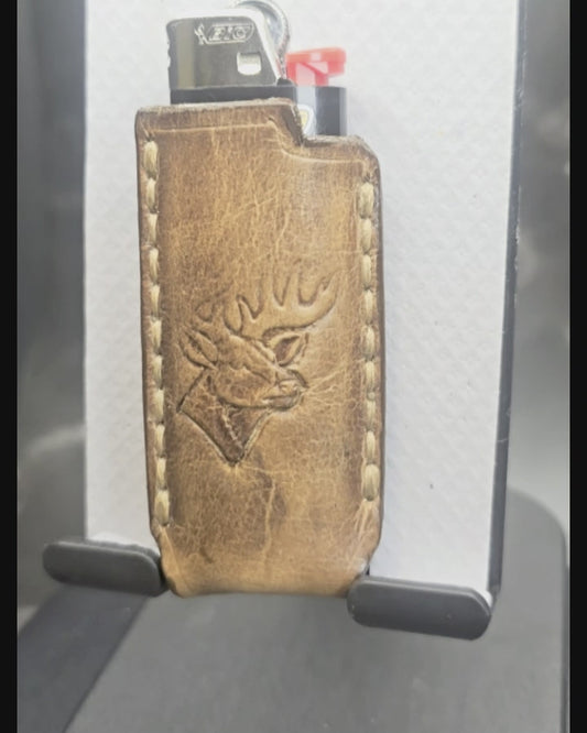 Video of a hand-crafted veg-tan leather lighter case for bic lighters with a deer stamped into it. Canadian made.