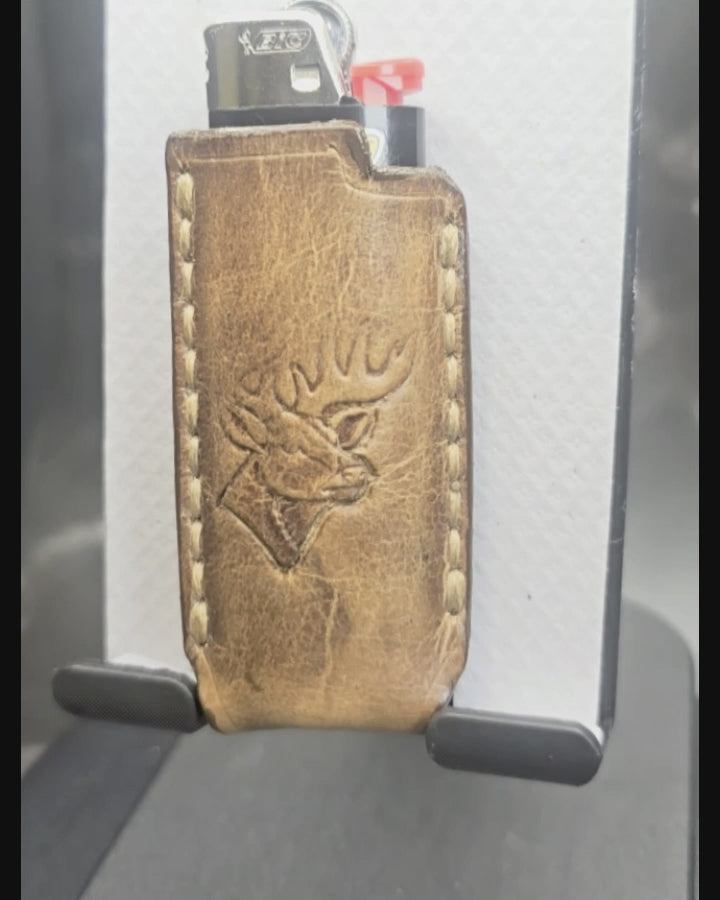 Video of a hand-crafted veg-tan leather lighter case for bic lighters with a deer stamped into it. Canadian made.