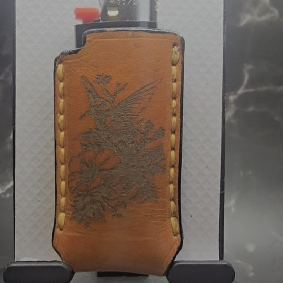 Video of a Canadian crafted veg-tan leather lighter case for bic lighters with a hummingbird on one side and a wolf on the other. Canadian made.