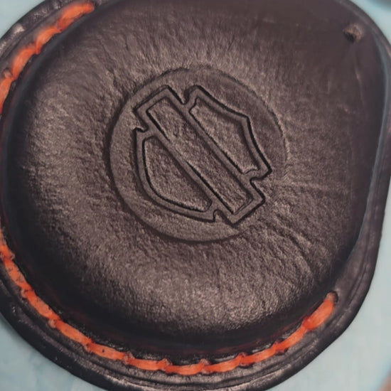 Video of a black Vegetable tanned leather key fob case for Harley Davidson motorcycles with orange stitching.
