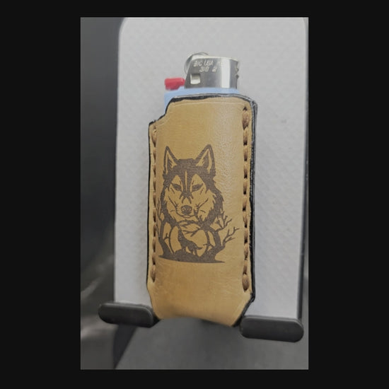 Video of a light brown veg-tan leather Bic lighter case with wolf laser engraved into it.