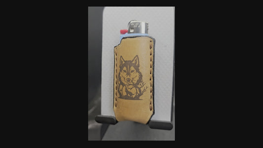 Video of a light brown veg-tan leather Bic lighter case with wolf laser engraved into it.