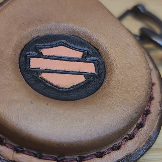 Video of a brown leather key fob case with orange Harley Davidson logo for Harley Davidson motorcycles